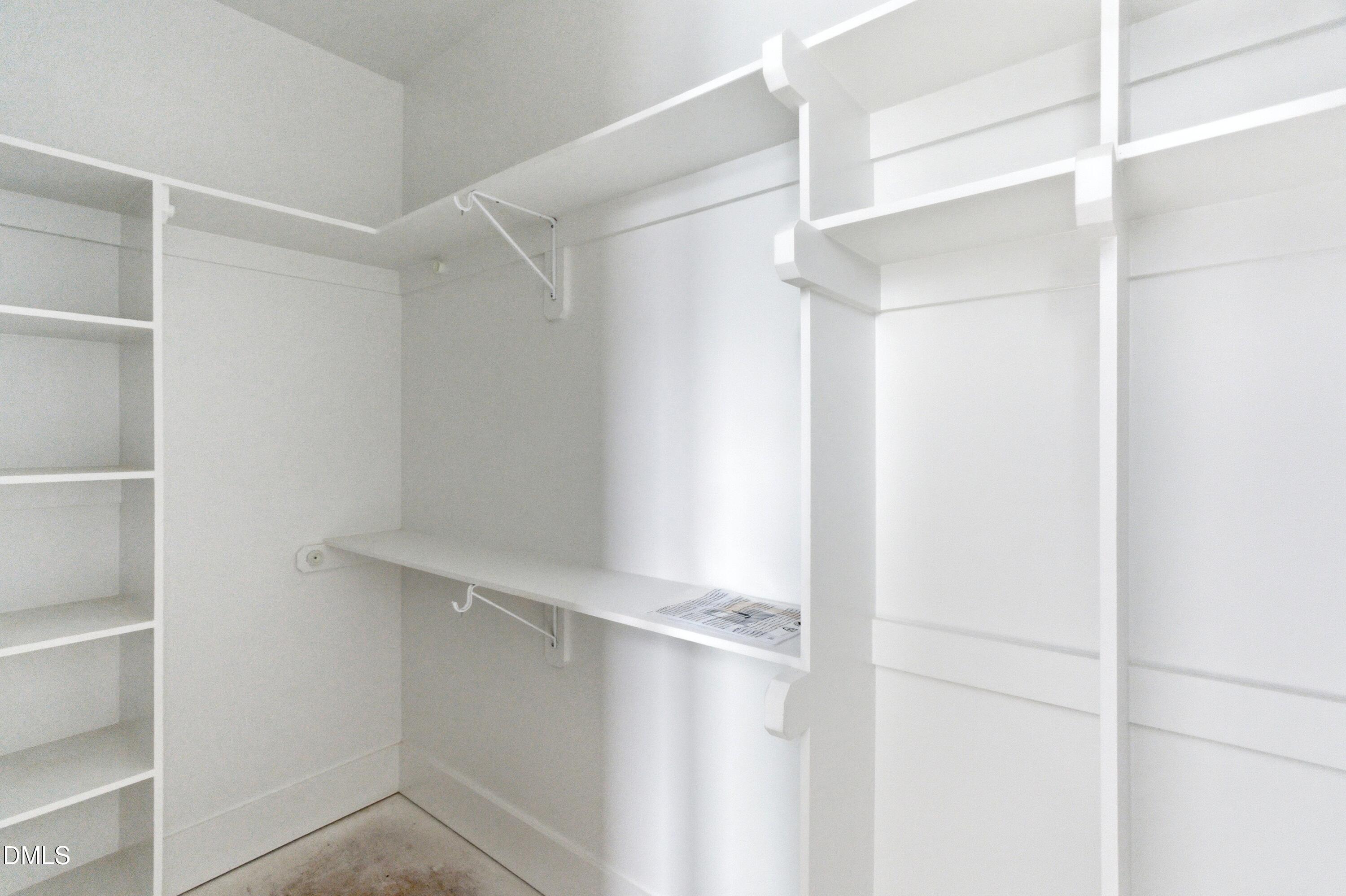 720 Noble Town Way, Unit 105 Raleigh, NC 27603 - Photo 13 of 23 a view of walk in closet with empty racks