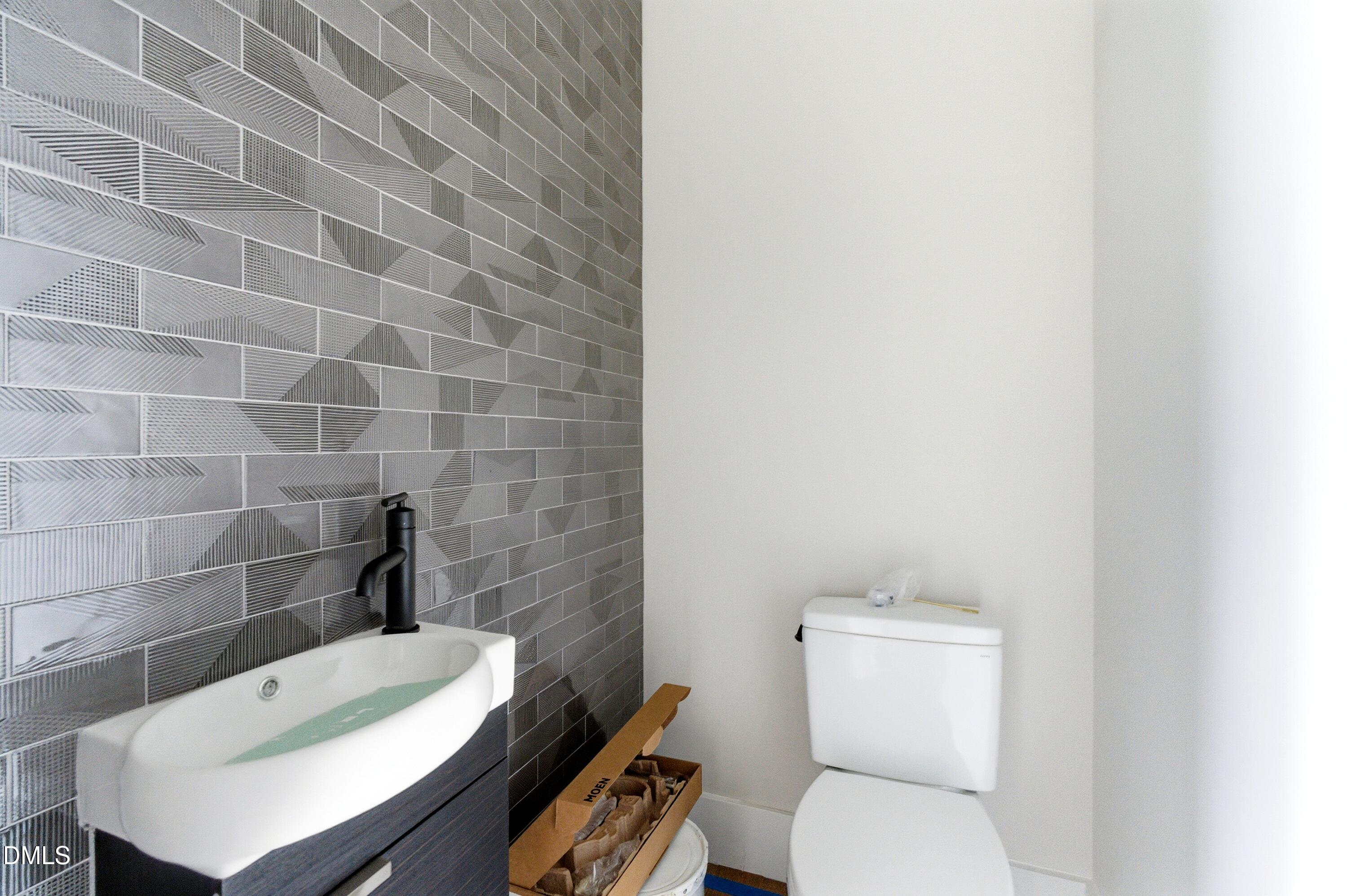 720 Noble Town Way, Unit 105 Raleigh, NC 27603 - Photo 9 of 23 a white toilet sitting next to a bathroom sink