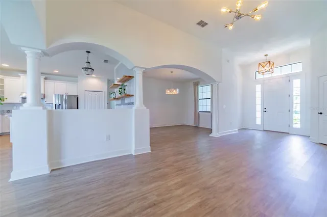 a large kitchen with stainless steel appliances granite countertop a sink a stove a refrigerator and island