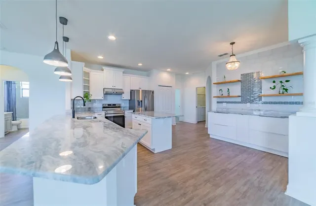 a view of a livingroom with wooden floor and stairs