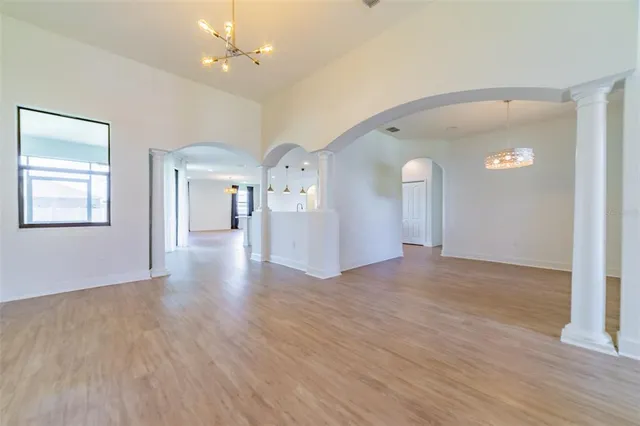 a large kitchen with stainless steel appliances granite countertop a lot of counter space and wooden floors