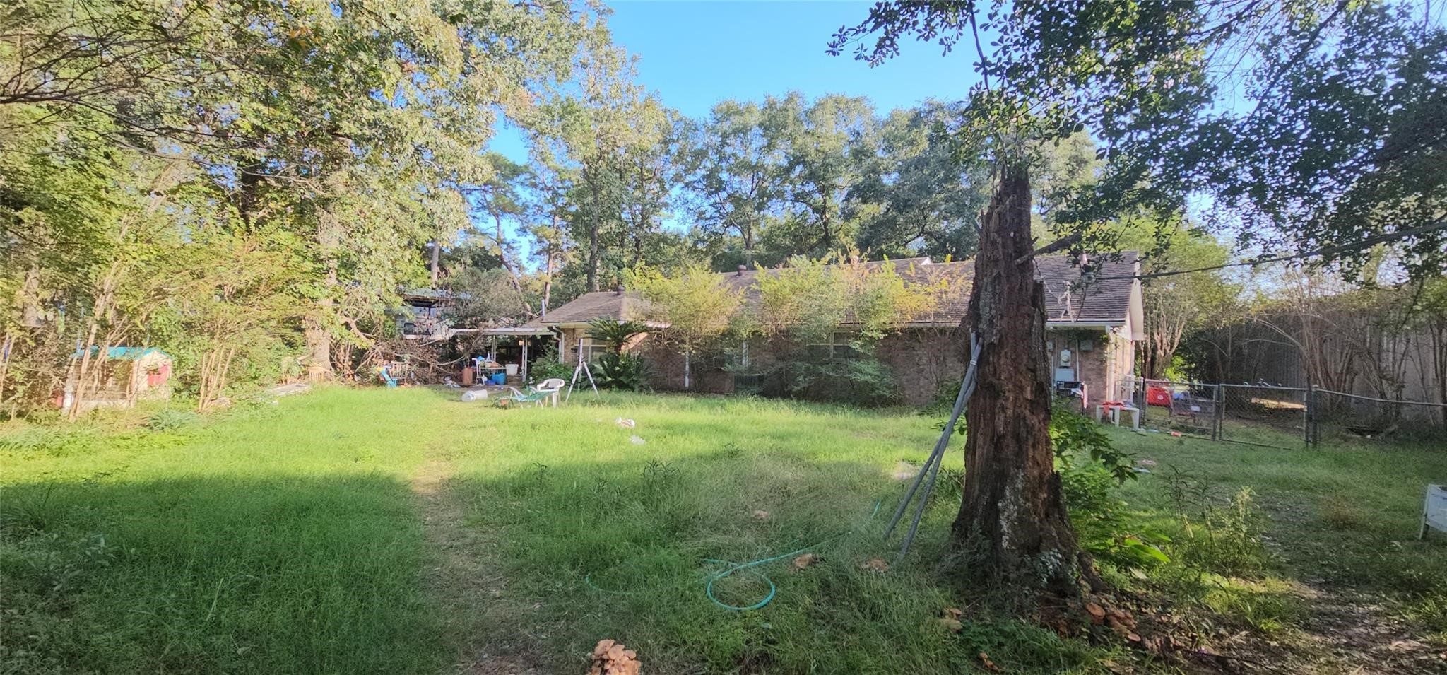119 Heatherwood Drive Spring, TX 77386 - Photo 13 of 16 a backyard of a house with table and chairs