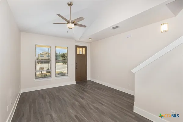a view of a room with wooden floor and staircase