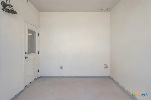 a kitchen with a refrigerator and a stove top oven