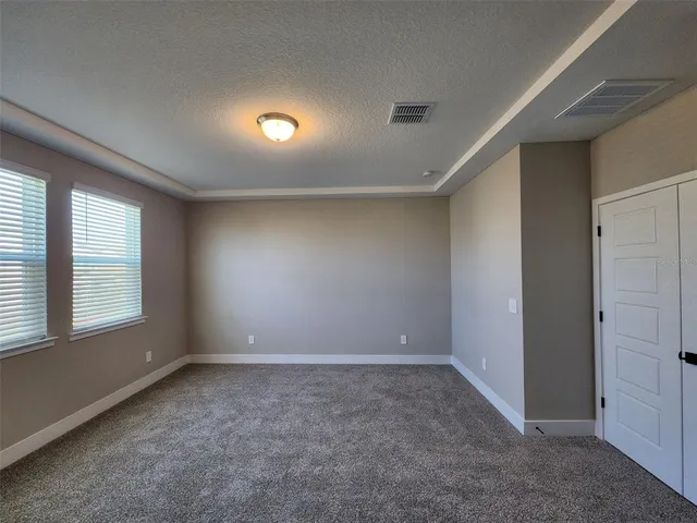 an empty room with a empty space and windows