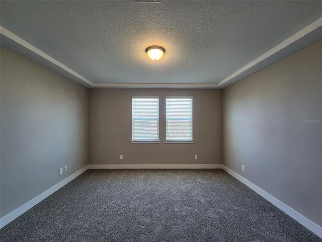 an empty room with a empty space and windows