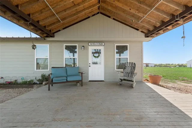 a view of a room with chairs and table