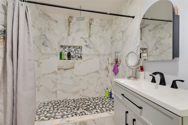 a bathroom with a sink and a shower