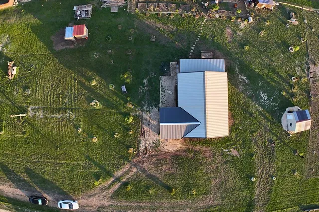 an aerial view of residential houses with outdoor space