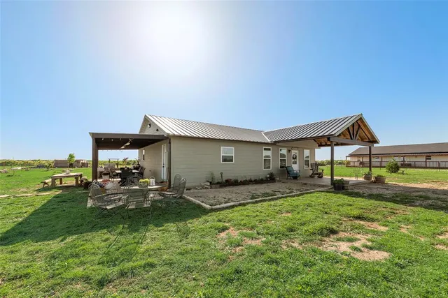 a house view with a sitting space and garden