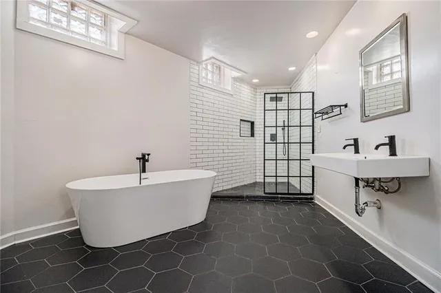 a bathroom with a bathtub and shower