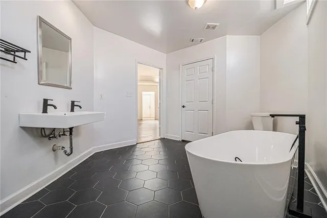 a bathroom with a bathtub and sink