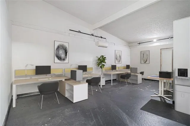 a living room with furniture a clock on wall and a window