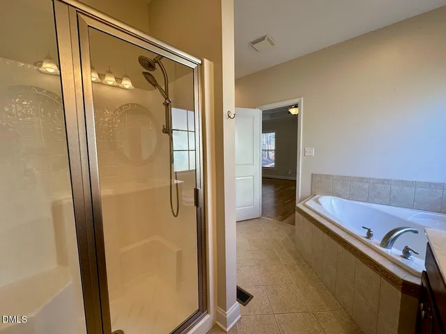 a bathroom with a tub and a shower