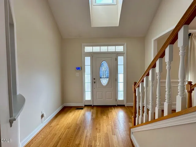 a view of an entryway with wooden floor