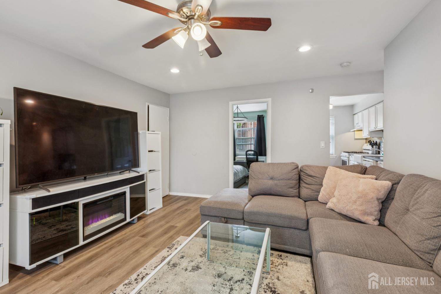 37 York Drive, Unit 6A Edison, NJ 08817 - Photo 1 of 20 a living room with furniture and a flat screen tv