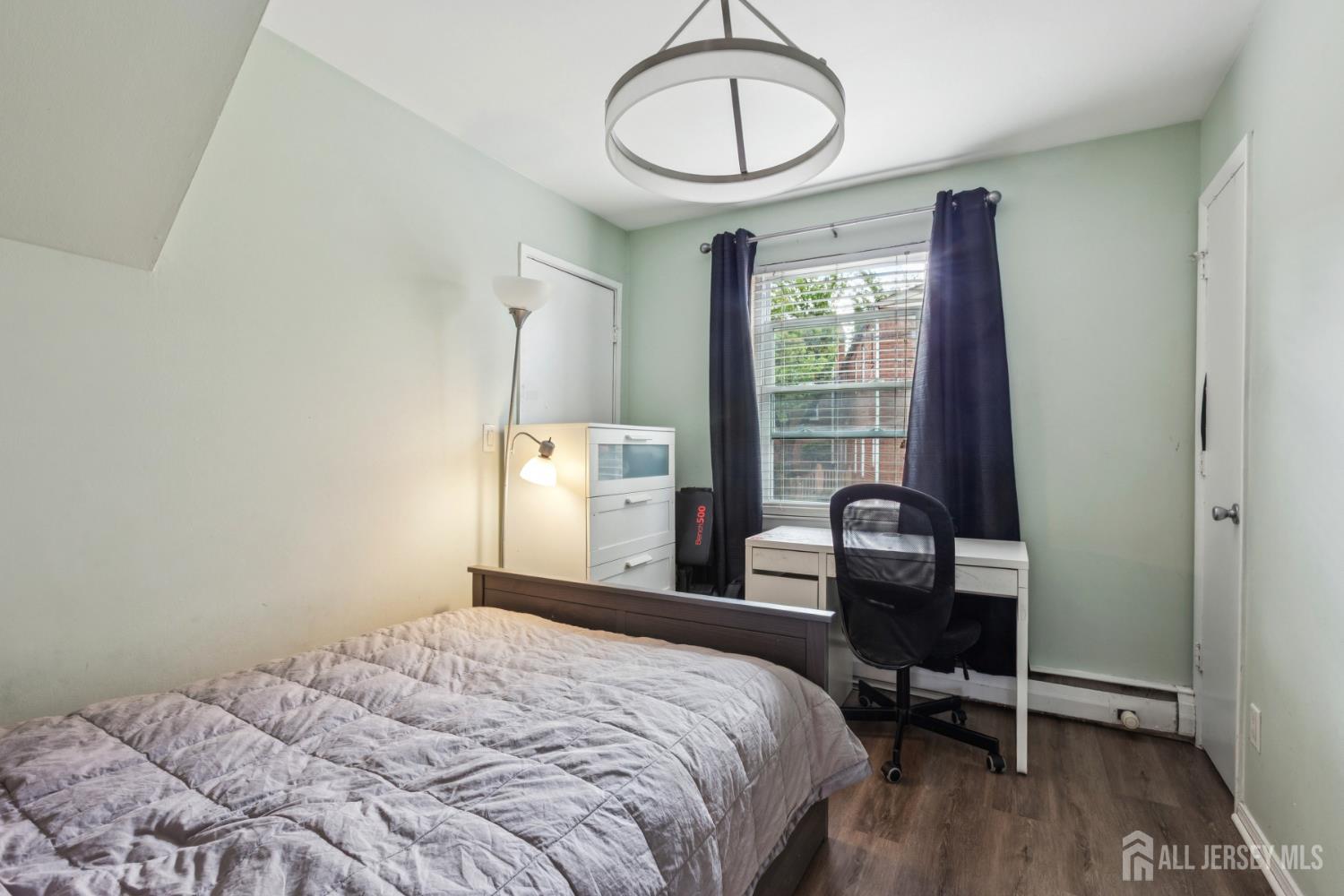 37 York Drive, Unit 6A Edison, NJ 08817 - Photo 13 of 20 a bedroom with a bed a desk and chair