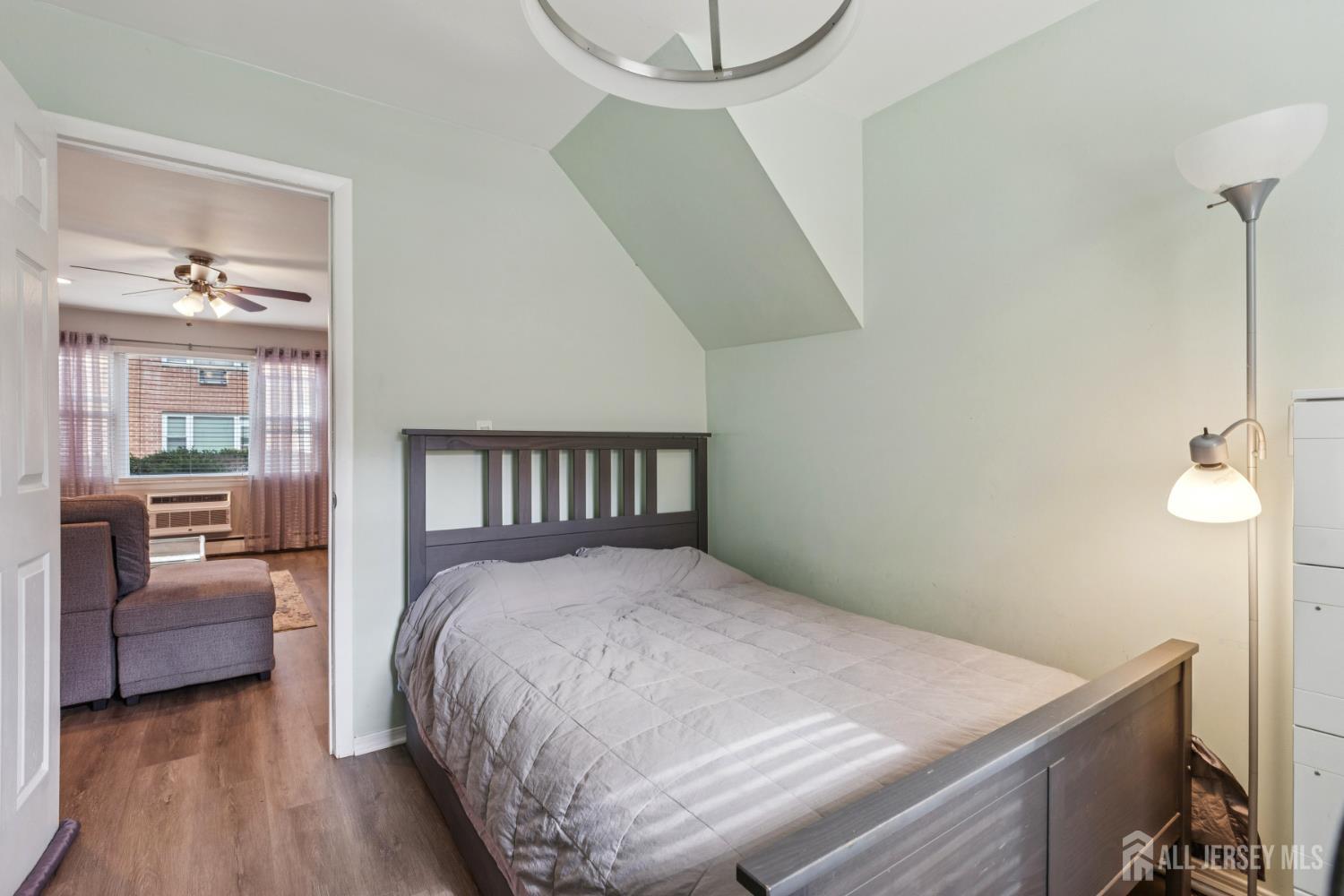 37 York Drive, Unit 6A Edison, NJ 08817 - Photo 14 of 20 a bedroom with a bed and a chandelier