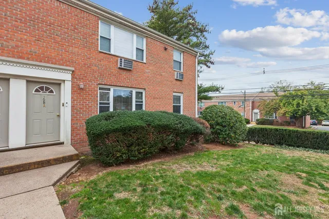 a view of a house with a yard and plants