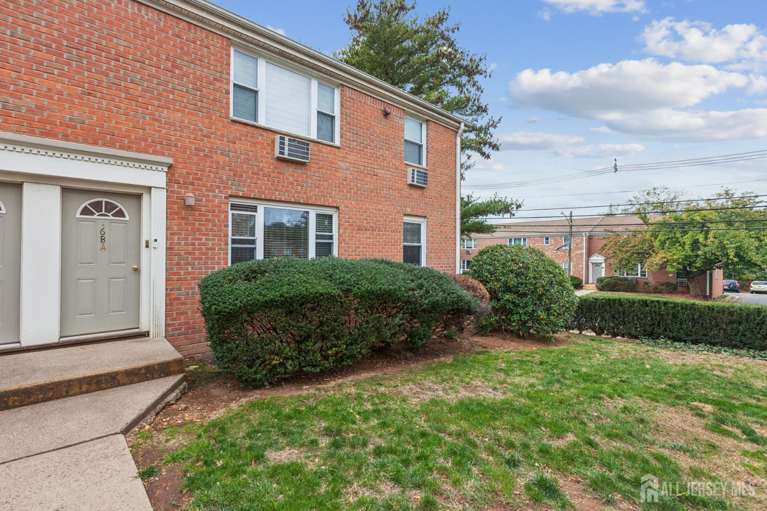 37 York Drive, Unit 6A Edison, NJ 08817 - Photo 19 of 20 a view of a house with a yard and plants