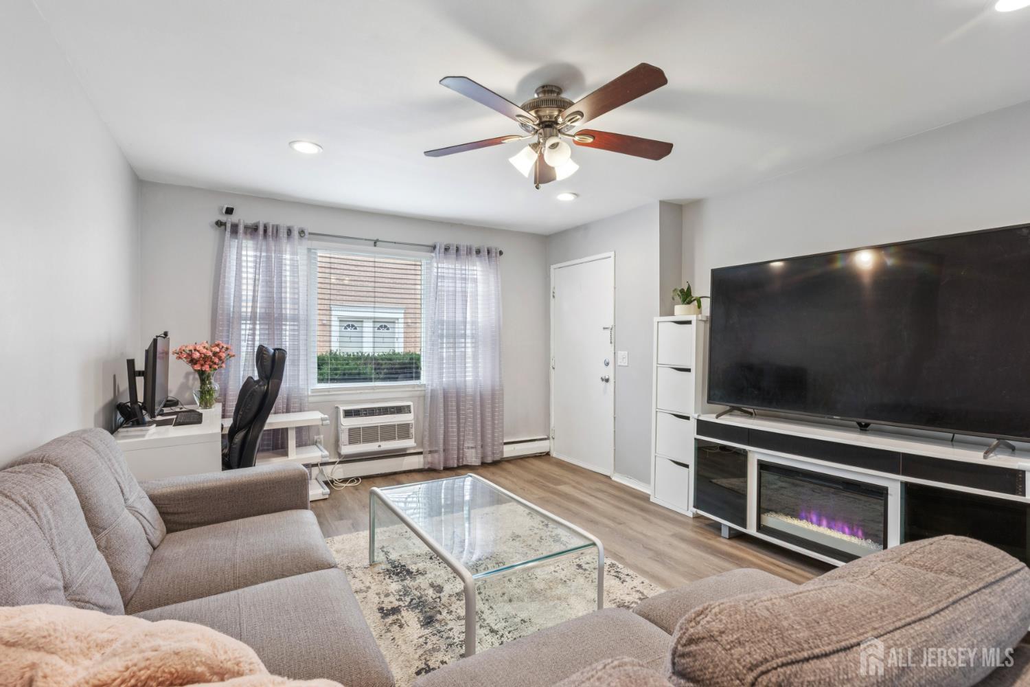 37 York Drive, Unit 6A Edison, NJ 08817 - Photo 3 of 20 a living room with furniture and a flat screen tv