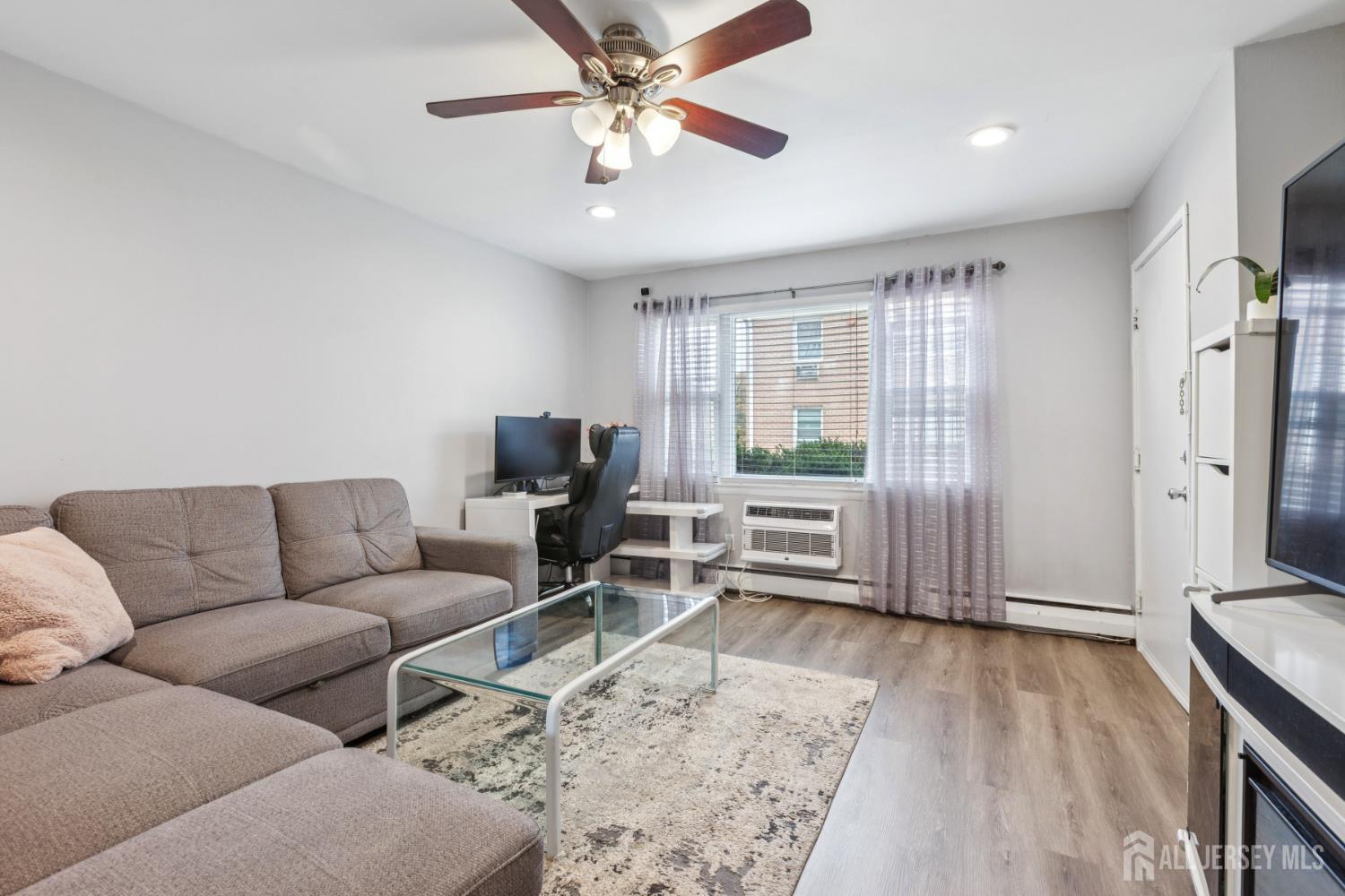 37 York Drive, Unit 6A Edison, NJ 08817 - Photo 4 of 20 a living room with furniture and a large window