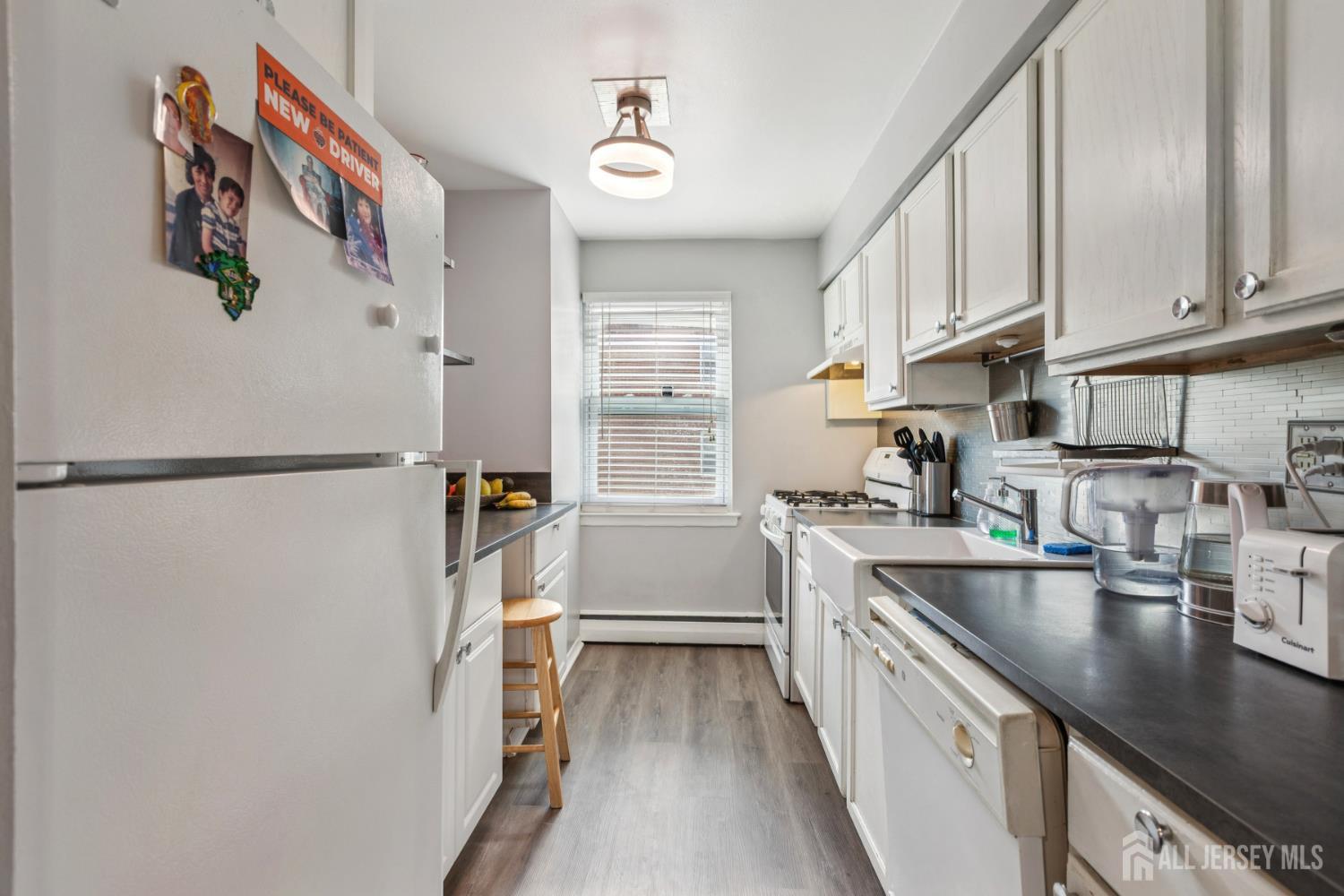 37 York Drive, Unit 6A Edison, NJ 08817 - Photo 5 of 20 a kitchen with stainless steel appliances granite countertop a refrigerator and a sink