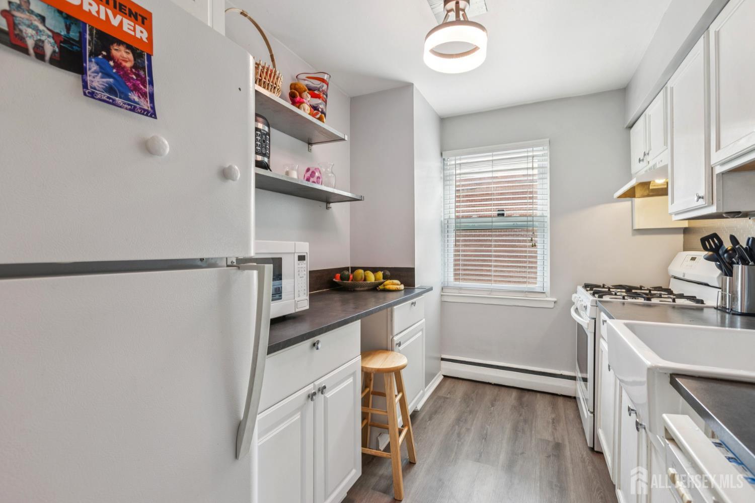 37 York Drive, Unit 6A Edison, NJ 08817 - Photo 6 of 20 a kitchen with stainless steel appliances granite countertop a sink stove and refrigerator