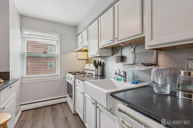 a kitchen with a sink a stove and cabinets