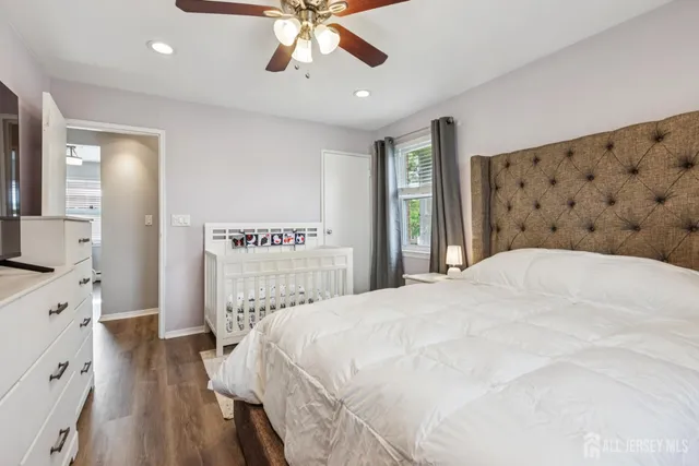 a bedroom with a large bed and a chandelier