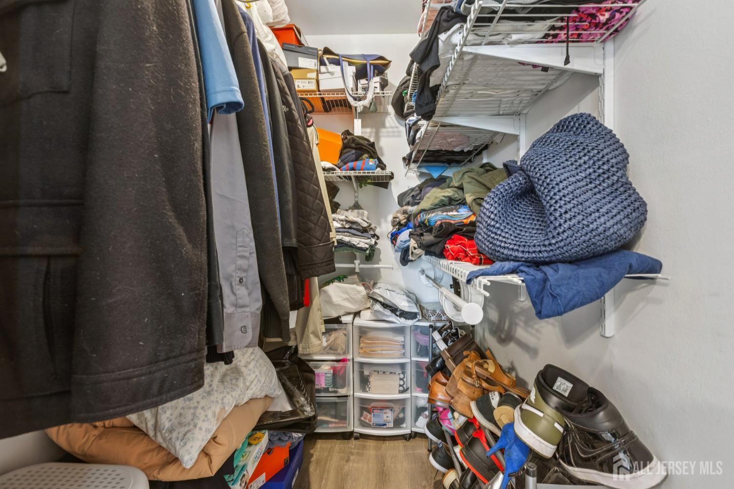 37 York Drive, Unit 6A Edison, NJ 08817 - Photo 10 of 20 a view of gym equipment with clothes and shoes