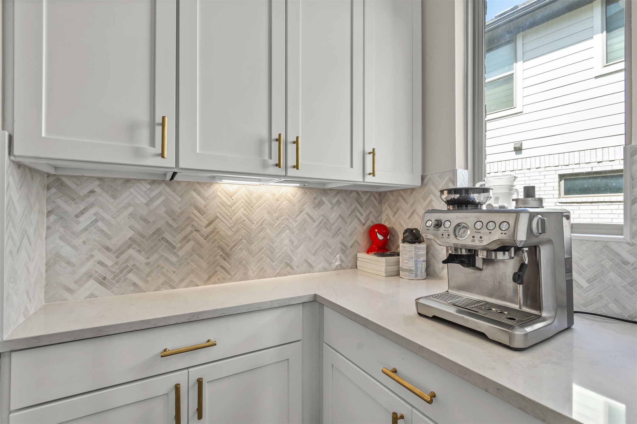 209 Azalea Spg Road Liberty Hill, TX 78642 - Photo 15 of 29 Corner kitchen counter with light-toned cabinetry and gold-tone hardware