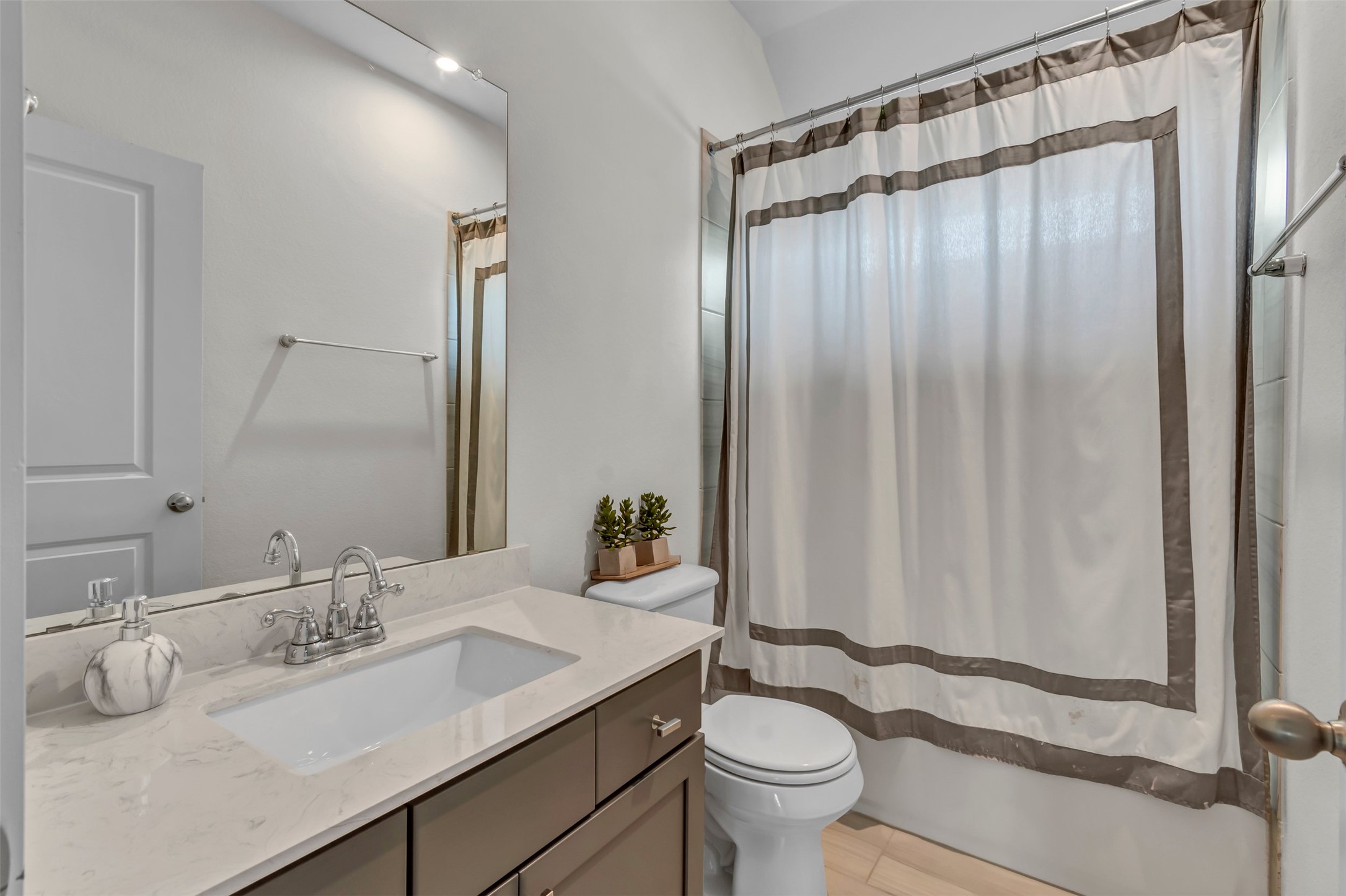 209 Azalea Spg Road Liberty Hill, TX 78642 - Photo 24 of 29 Bathroom featuring a vanity with a white countertop, undermount sink, and chrome faucet