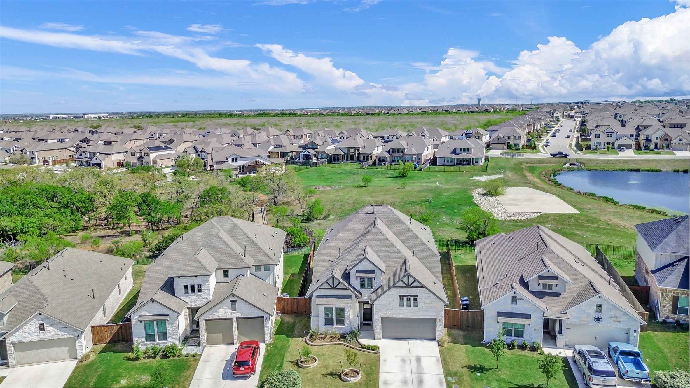 209 Azalea Spg Road Liberty Hill, TX 78642 - Photo 27 of 29 Contemporary two-story residence featuring a combination of stone and siding exterior, a two-car garage, and a gabled roofline