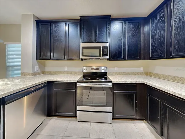 a kitchen with sink cabinets and stainless steel appliances
