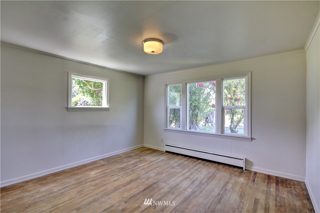 2353 Grandview Road Ferndale, WA 98248 - Photo 16 of 40 a view of an empty room with wooden floor and a window