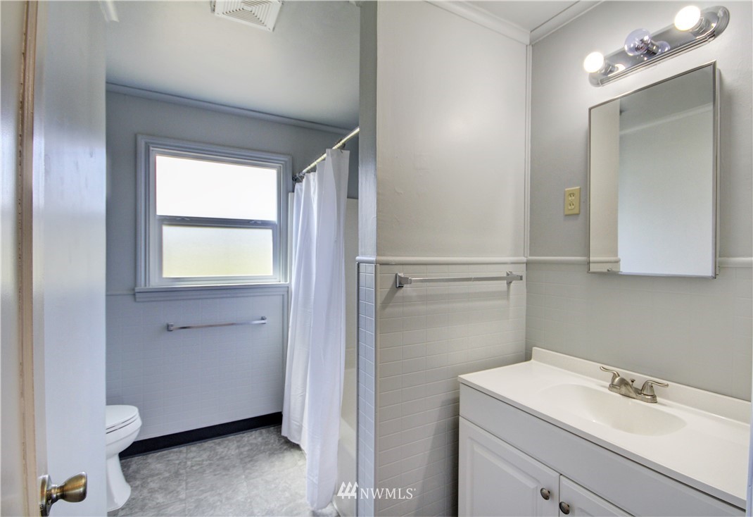 2353 Grandview Road Ferndale, WA 98248 - Photo 18 of 40 a bathroom with a sink a toilet and a mirror