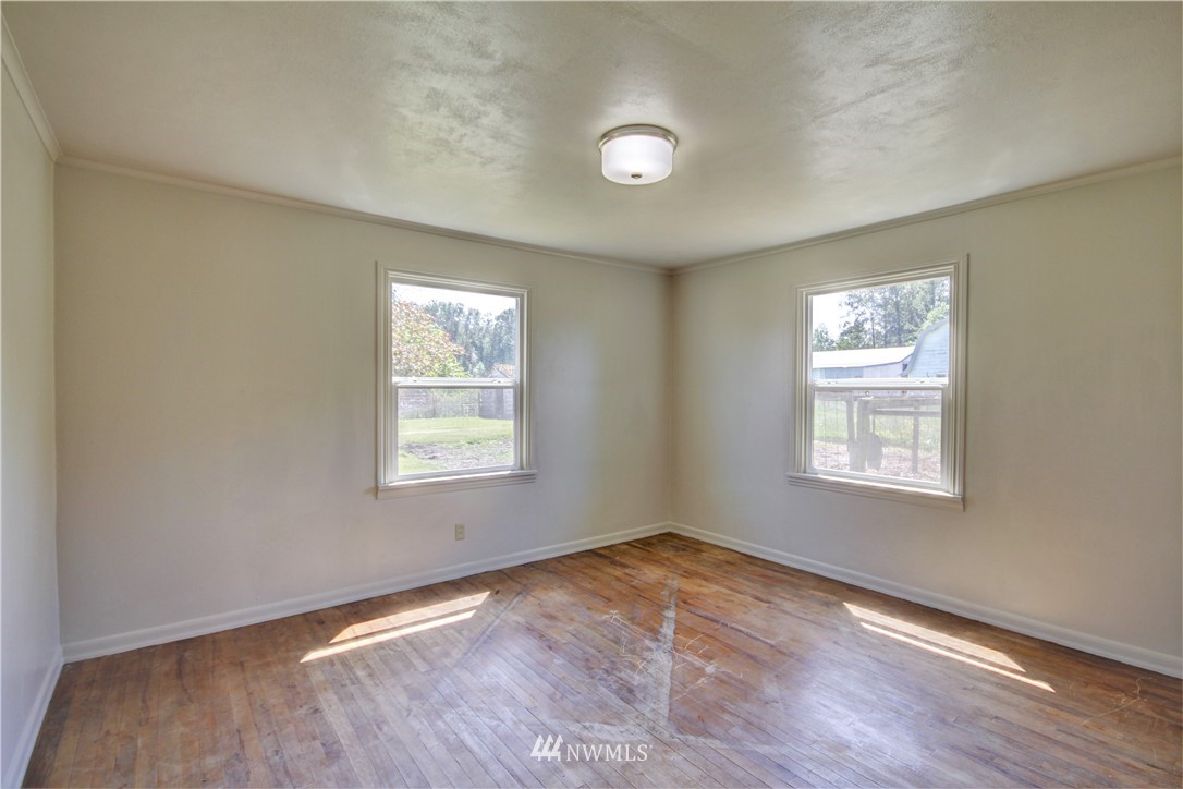 2353 Grandview Road Ferndale, WA 98248 - Photo 19 of 40 a view of an empty room with wooden floor and a window