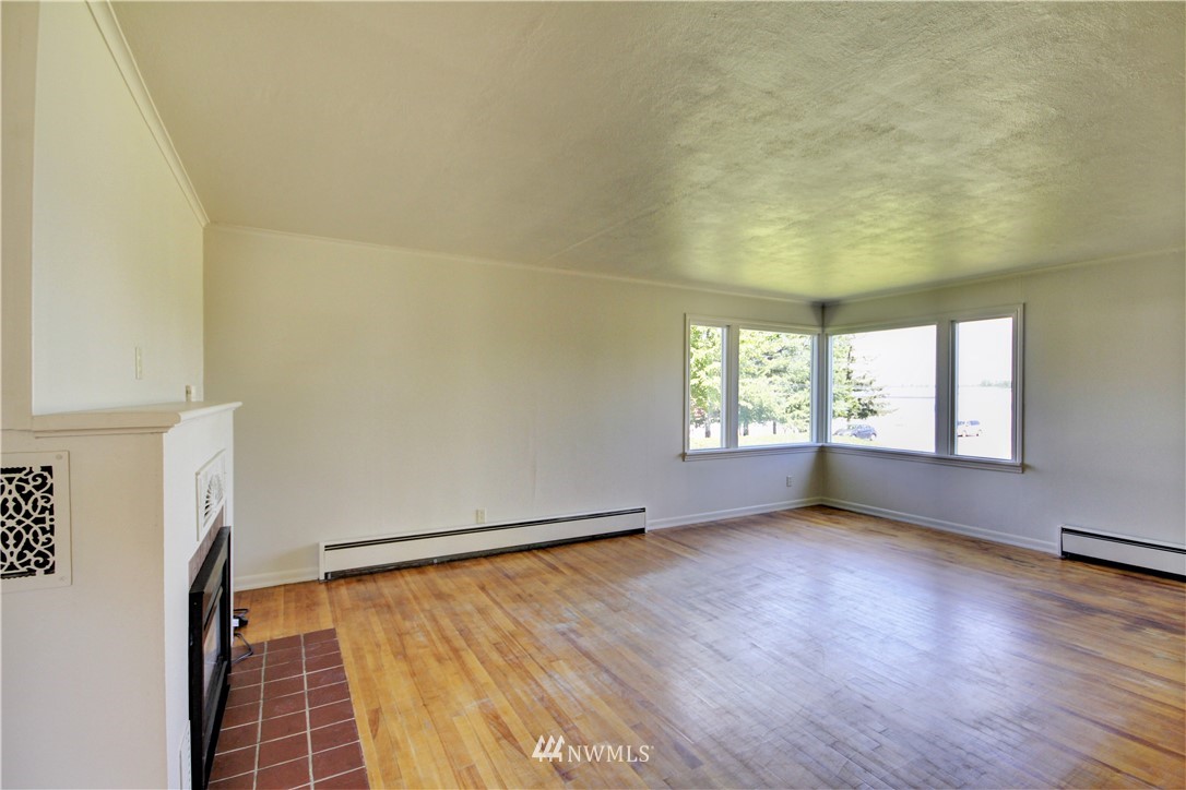 2353 Grandview Road Ferndale, WA 98248 - Photo 6 of 40 an empty room with wooden floor and windows