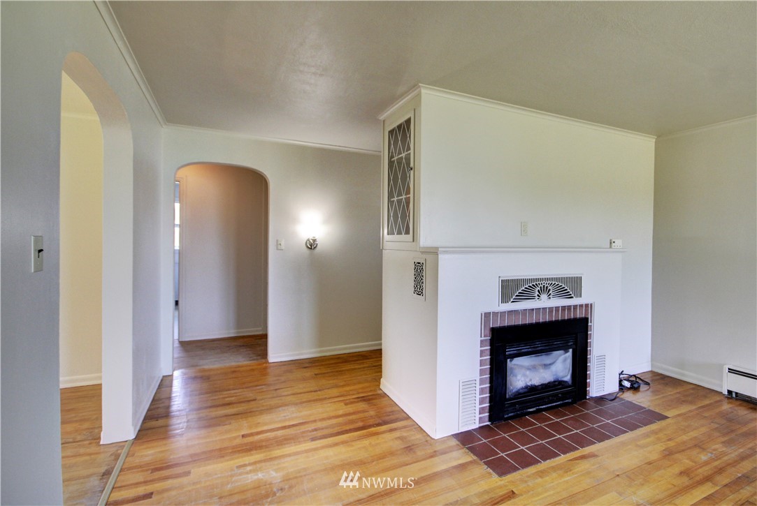 2353 Grandview Road Ferndale, WA 98248 - Photo 9 of 40 a view of an empty room with wooden floor and a fireplace