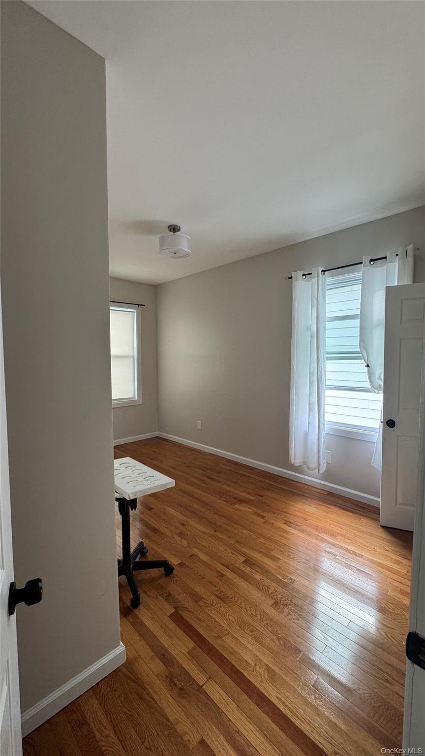 153 Chester Street, Unit 2 AND 3 Mount Vernon, NY 10552 - Photo 5 of 11 a view of empty room with wooden floor and fan