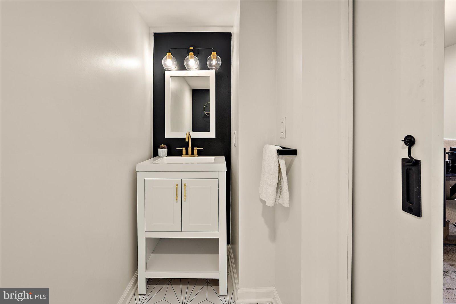 813 Shore Drive Edgewater, MD 21037 - Photo 18 of 64 a bathroom with a sink and mirror