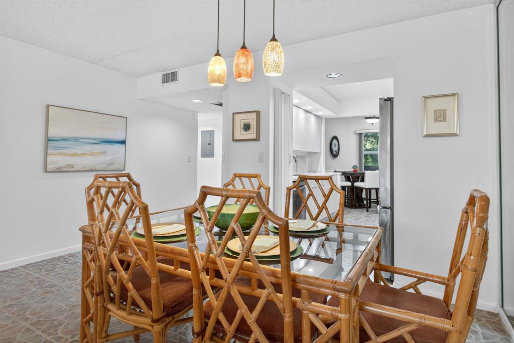 1801 Eleuthera Point, Unit D3 Coconut Creek, FL 33066 - Photo 14 of 80 a view of a dining room with furniture and chandelier
