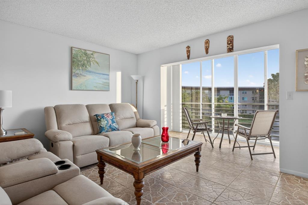 1801 Eleuthera Point, Unit D3 Coconut Creek, FL 33066 - Photo 16 of 80 a living room with furniture and a large window