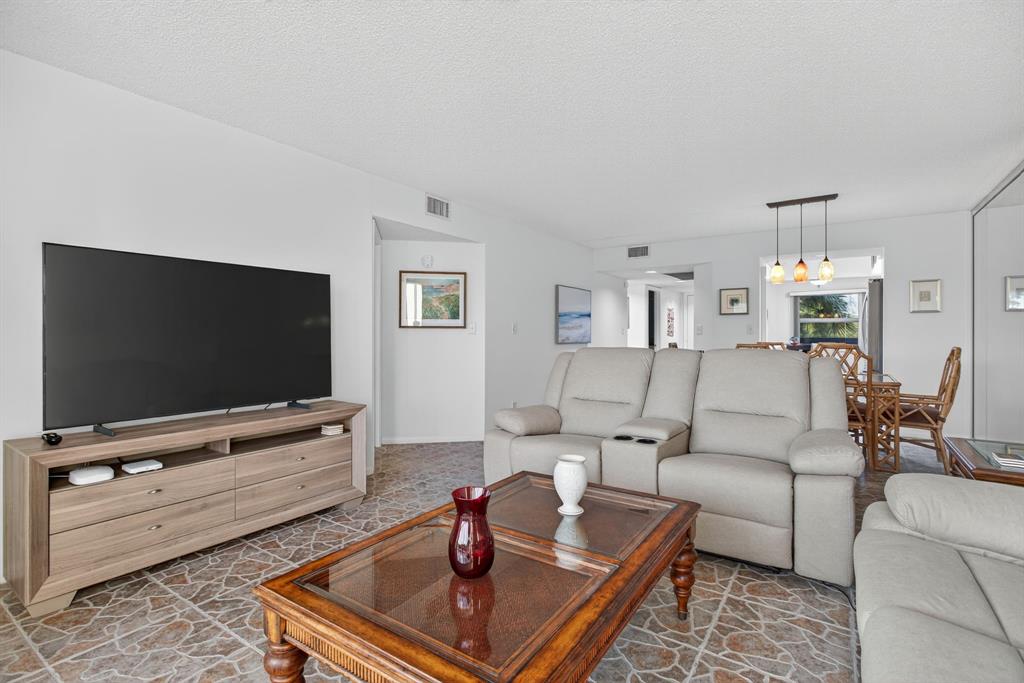 1801 Eleuthera Point, Unit D3 Coconut Creek, FL 33066 - Photo 18 of 80 a living room with furniture and a flat screen tv