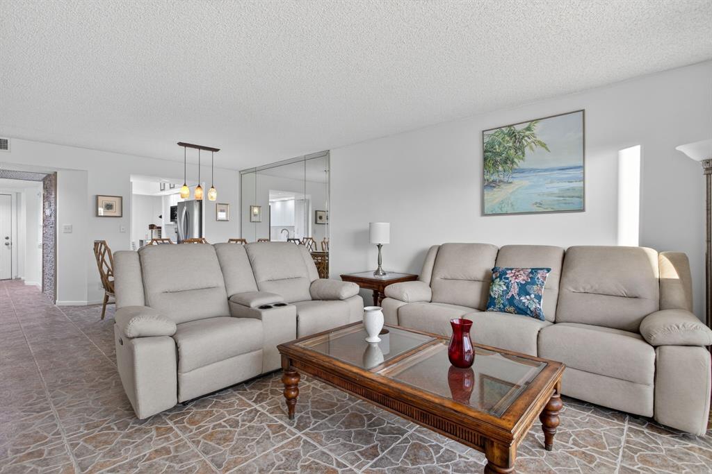 1801 Eleuthera Point, Unit D3 Coconut Creek, FL 33066 - Photo 19 of 80 a living room with furniture and a rug
