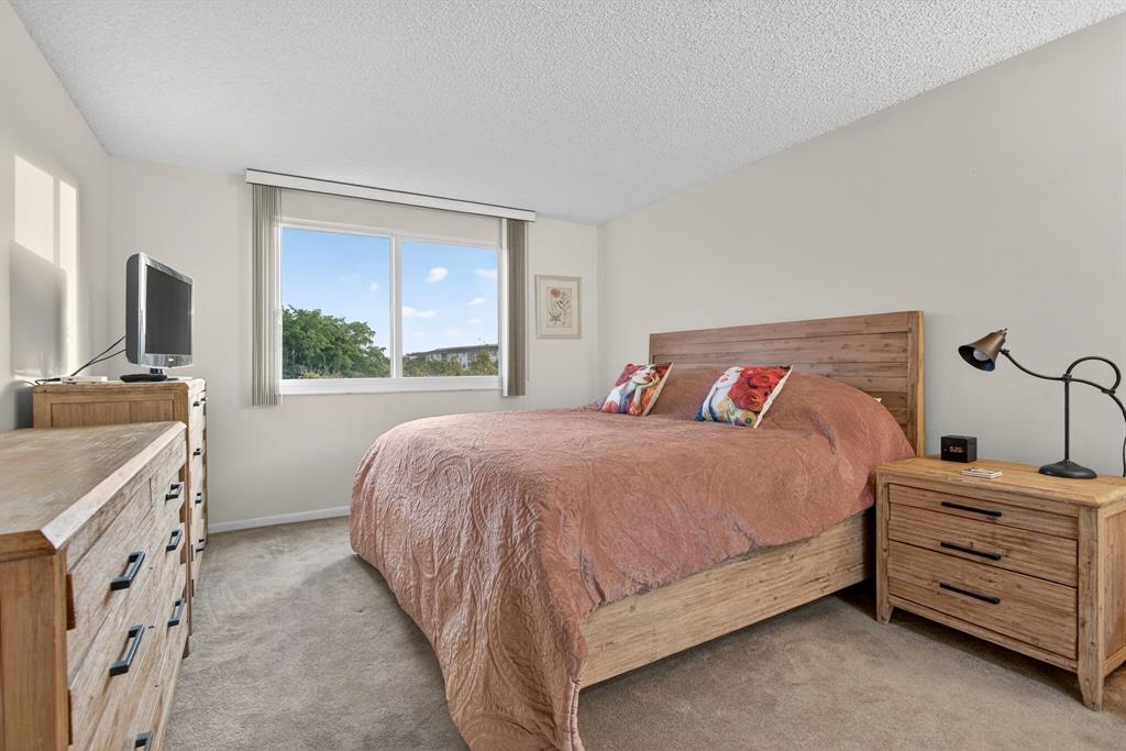 1801 Eleuthera Point, Unit D3 Coconut Creek, FL 33066 - Photo 25 of 80 a bedroom with a bed and a dresser