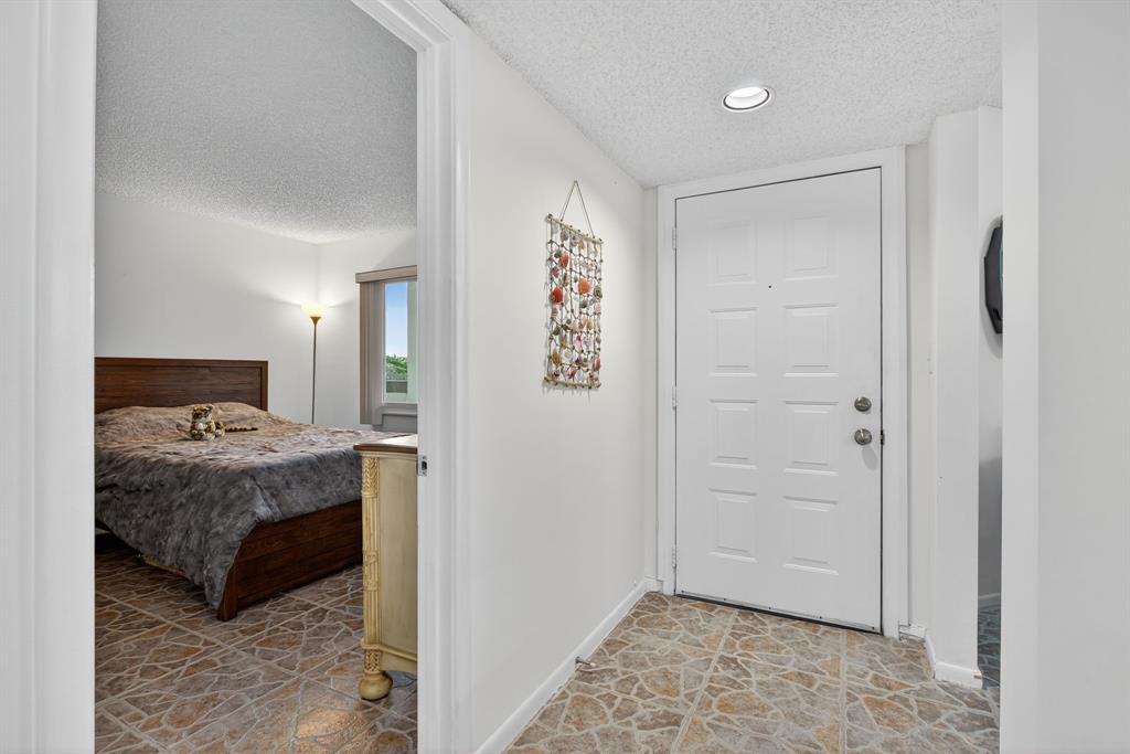 1801 Eleuthera Point, Unit D3 Coconut Creek, FL 33066 - Photo 32 of 80 a bedroom with a bed and a painting on the wall