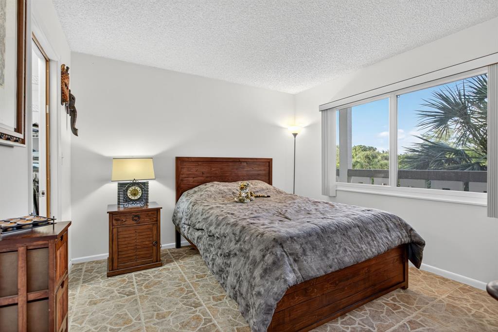 1801 Eleuthera Point, Unit D3 Coconut Creek, FL 33066 - Photo 33 of 80 a bedroom with a large bed and a dresser