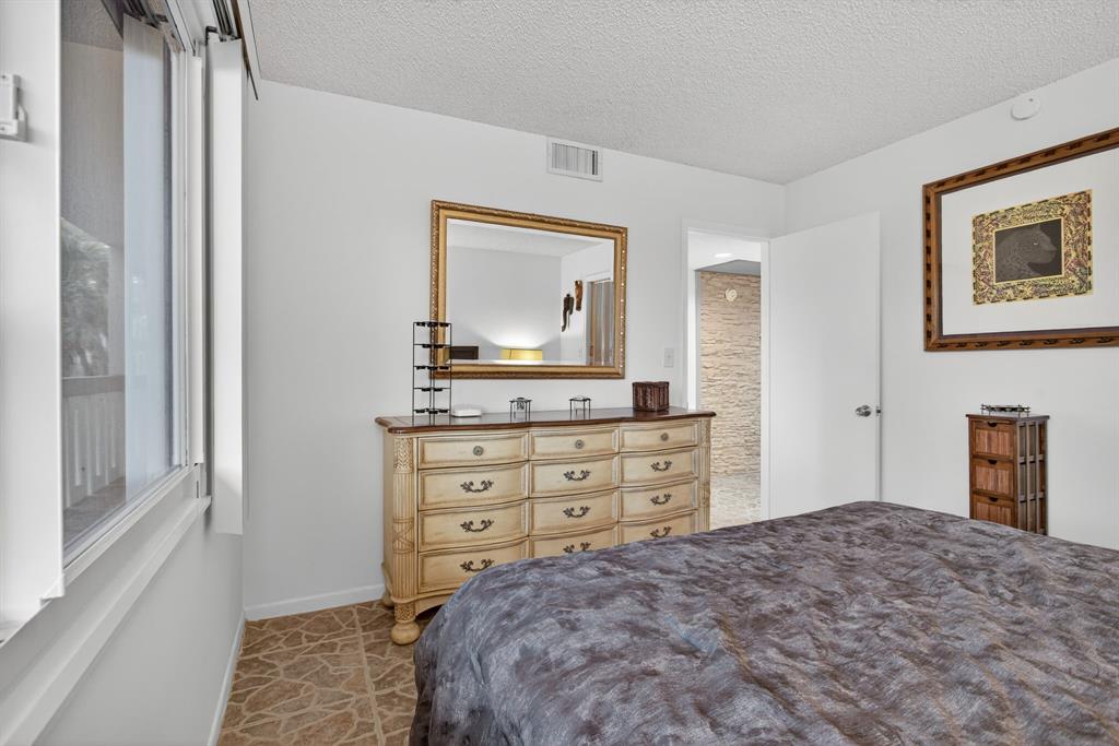 1801 Eleuthera Point, Unit D3 Coconut Creek, FL 33066 - Photo 34 of 80 a bedroom with a bed and a dresser in it